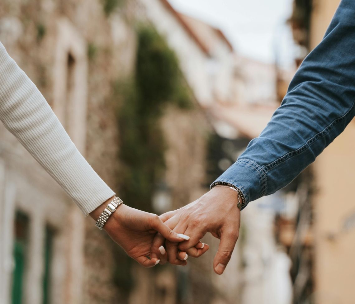 close up of a man and a woman holding hands